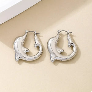 Silver dolphin hoop earrings with a polished finish.