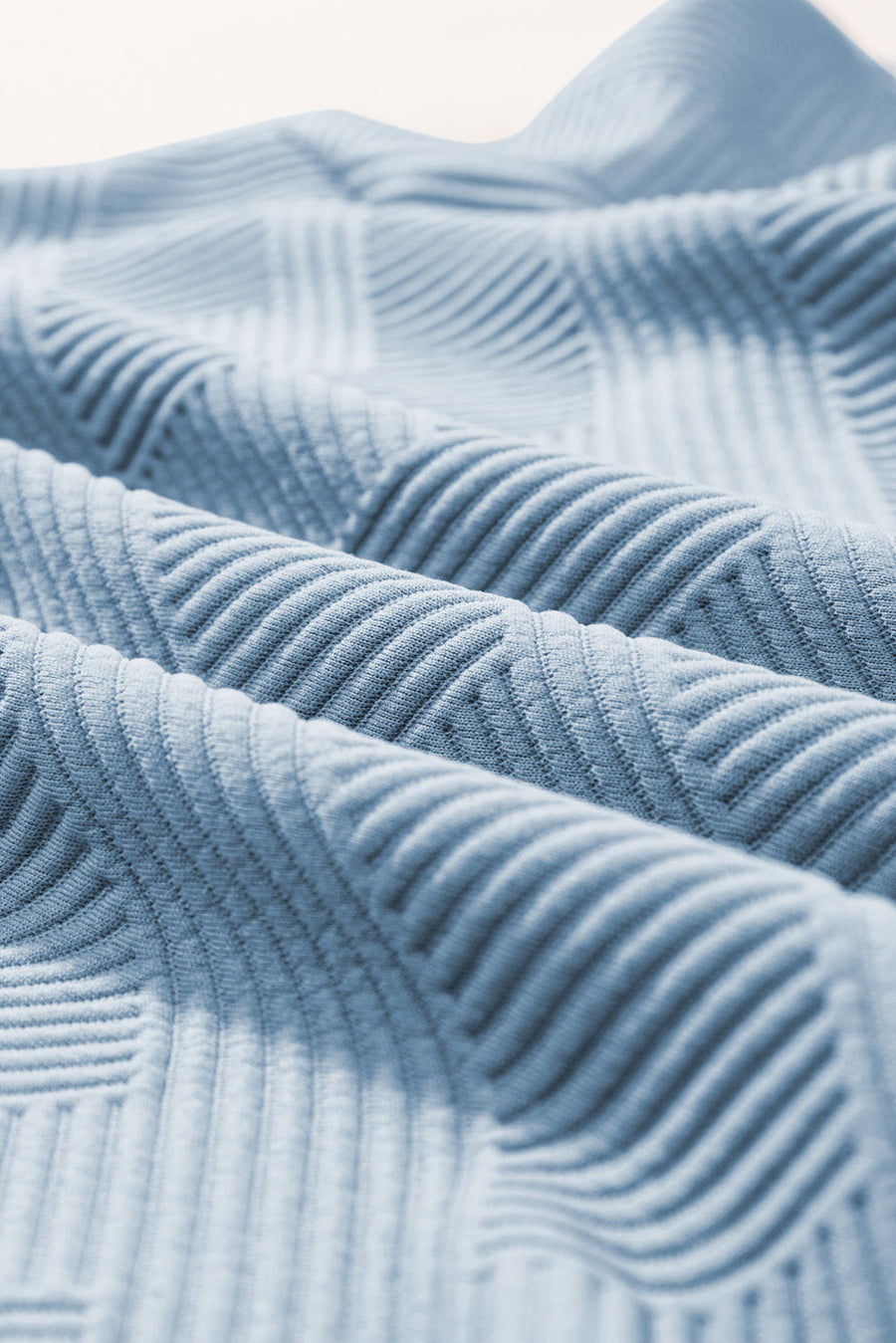 Light blue textured knit culottes with a subtle geometric pattern detail.