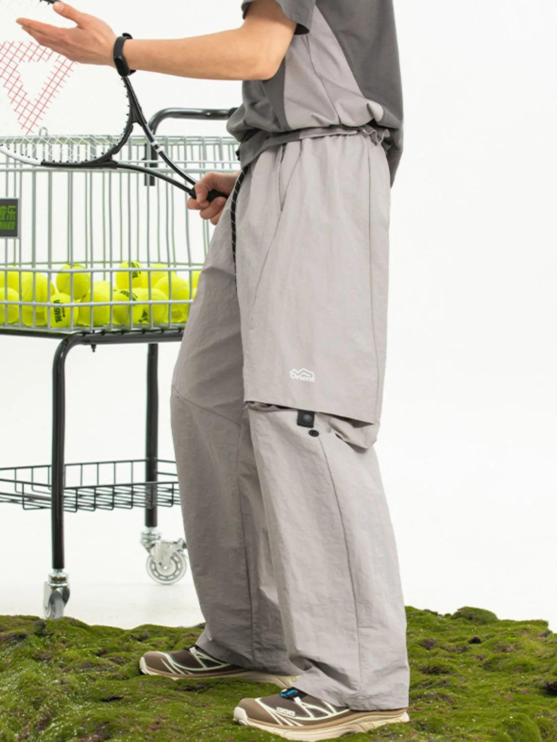 Convertible cargo pants in gray with multiple pockets and a relaxed fit.