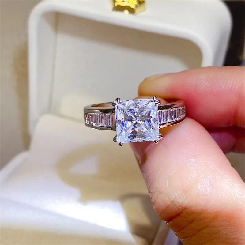 Princess cut diamond ring with baguette band in silver.