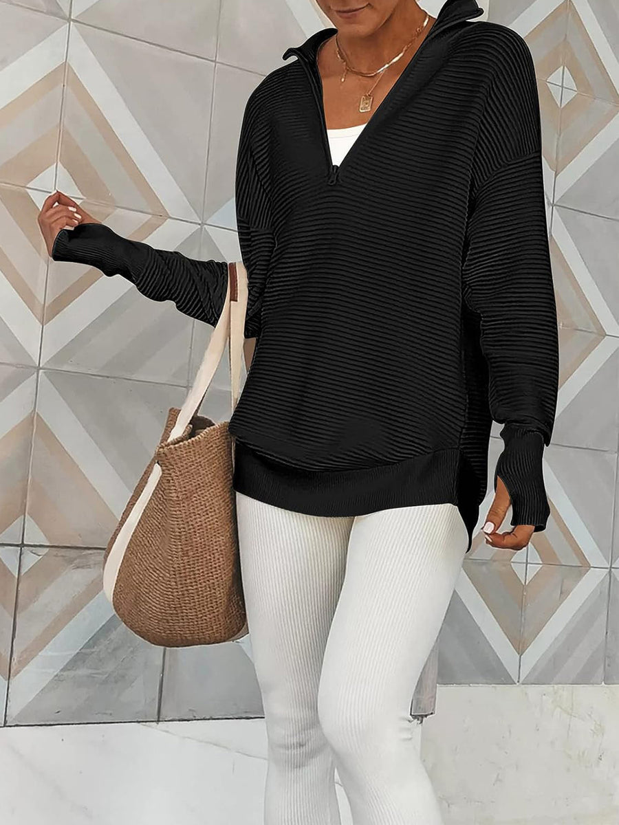 Black ribbed knit pullover with funnel neck and quarter zip, long sleeves with thumbholes.