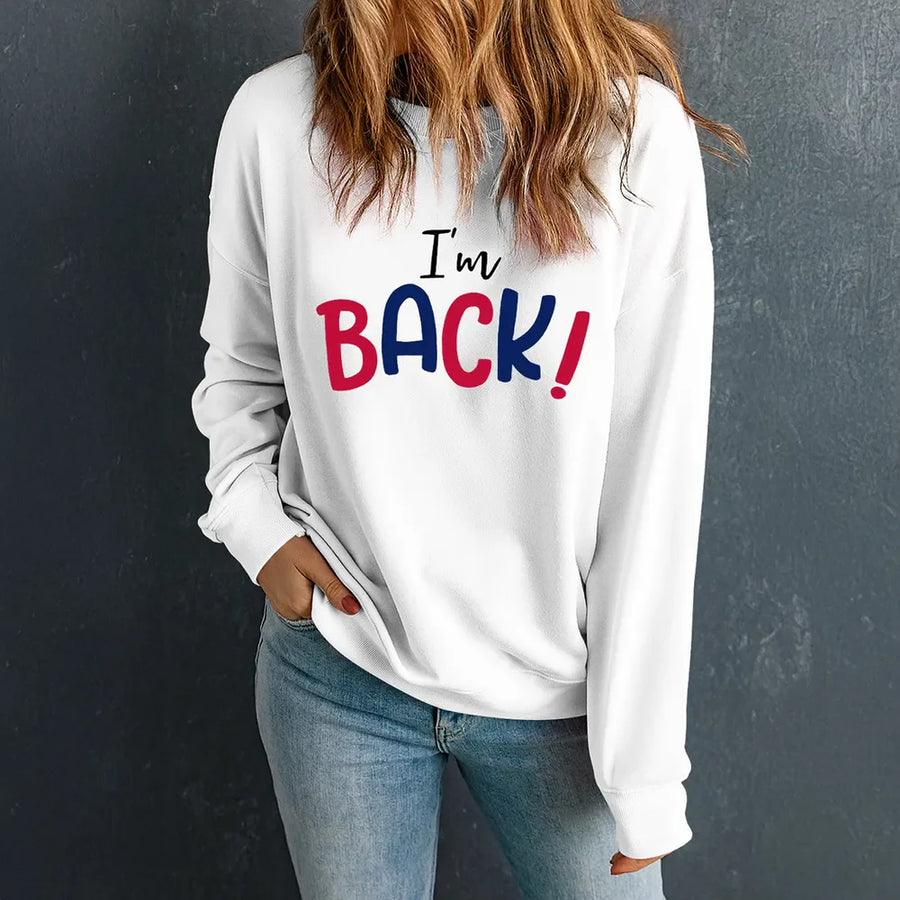 White crewneck sweatshirt with I'm Back! graphic in red and blue text