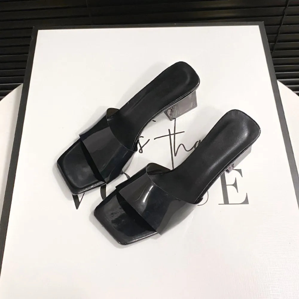 Black lucite heel square toe mules with clear block heel.