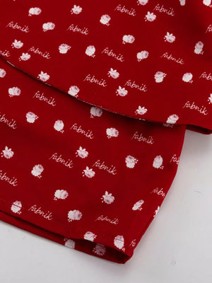 Red fabric with white floral print and "fabrik" text pattern
