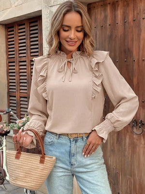 Chic beige long sleeve shirt with tie-neck and ruffled details