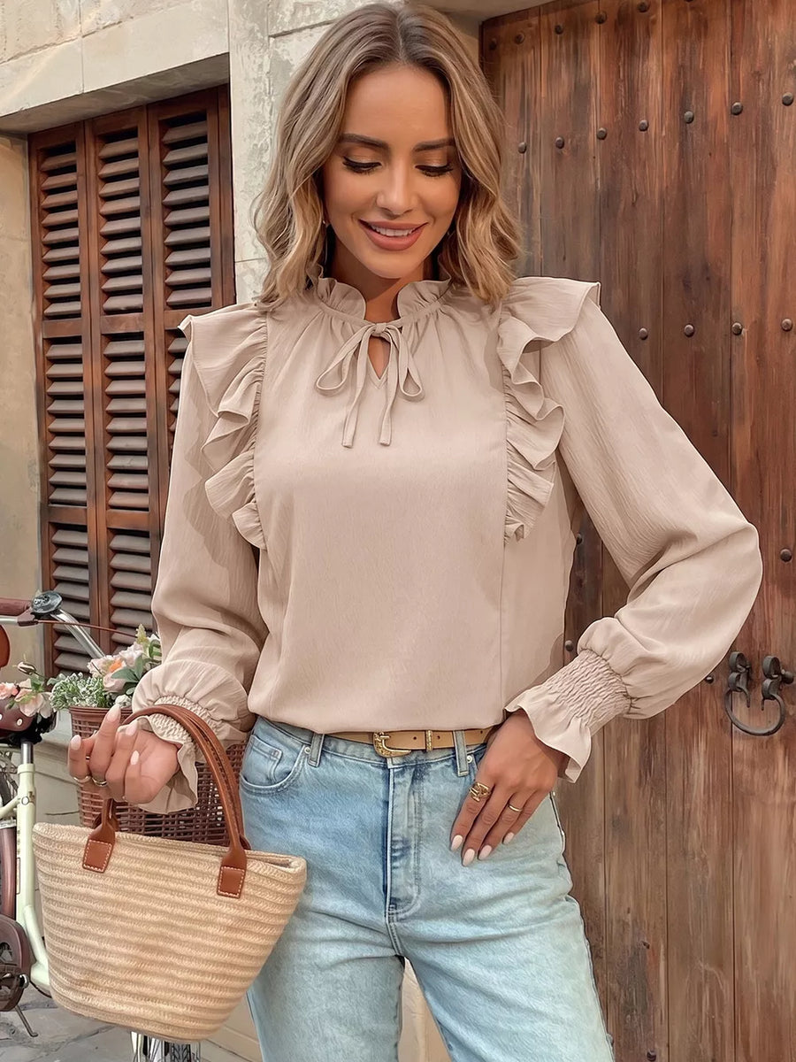 Chic beige long sleeve shirt with tie-neck and ruffled details