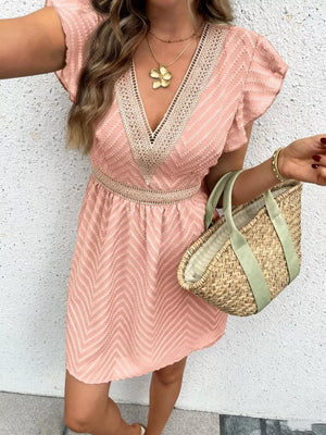 Chevron textured mini dress in watermelon pink with lace trim and defined waist.