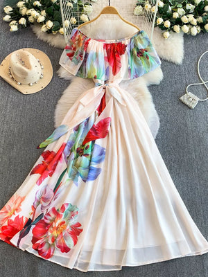 Botanical off-shoulder A-line dress in light pink with a floral print and belted waist.