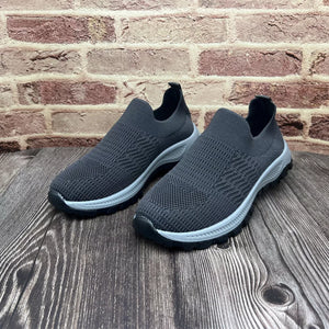 Grey breathable slip-on sneakers with round toe and textured knit upper.