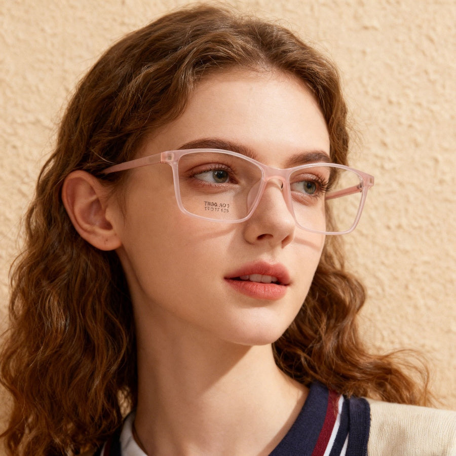 Trendy square optical glasses in blush pink with clear lenses, on a woman.