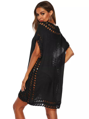 Black crochet V-neck cover-up dress with cutout details and fringe hem.