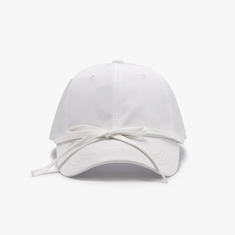 White baseball cap with a tied back bow detail