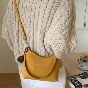 Yellow suede crossbody bag with charm and adjustable strap