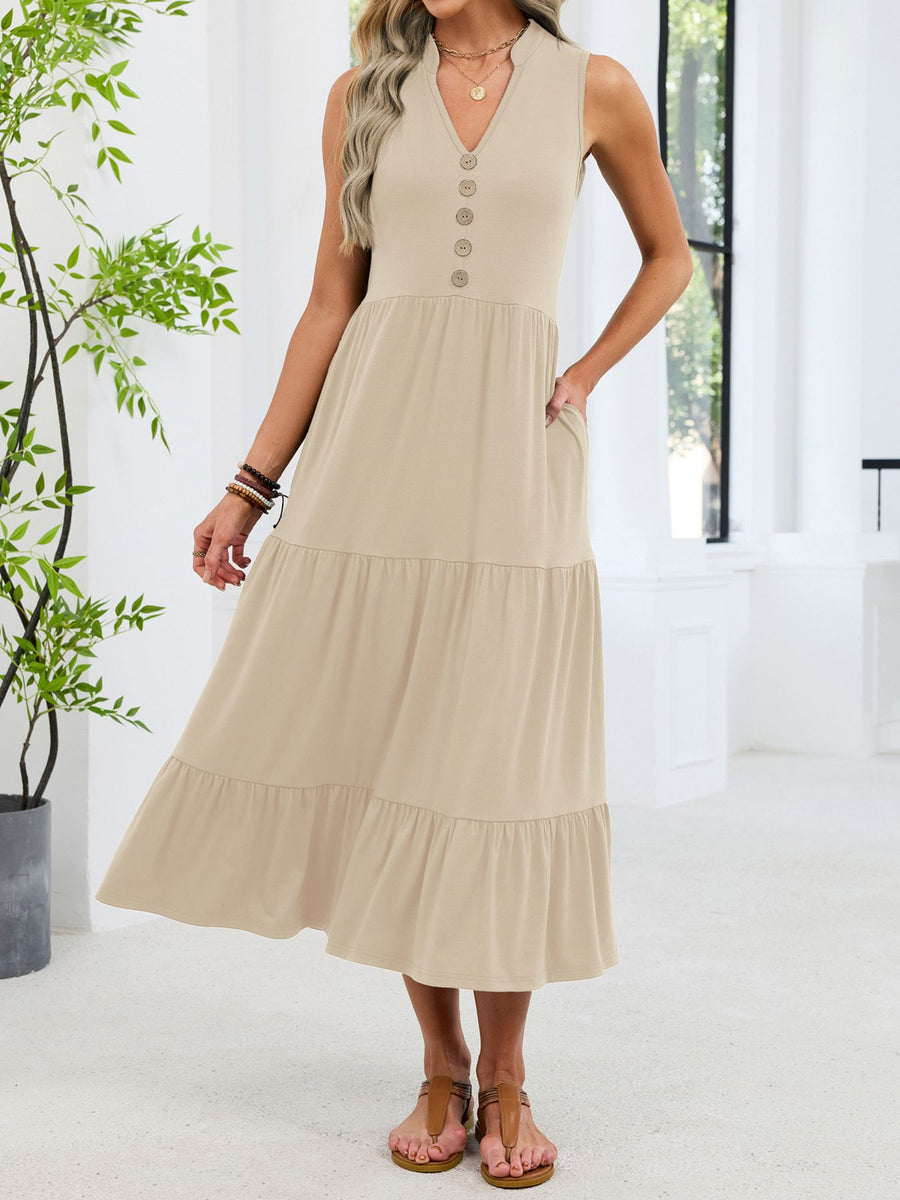 Apricot tiered midi dress with V-neck, decorative buttons, and pockets.