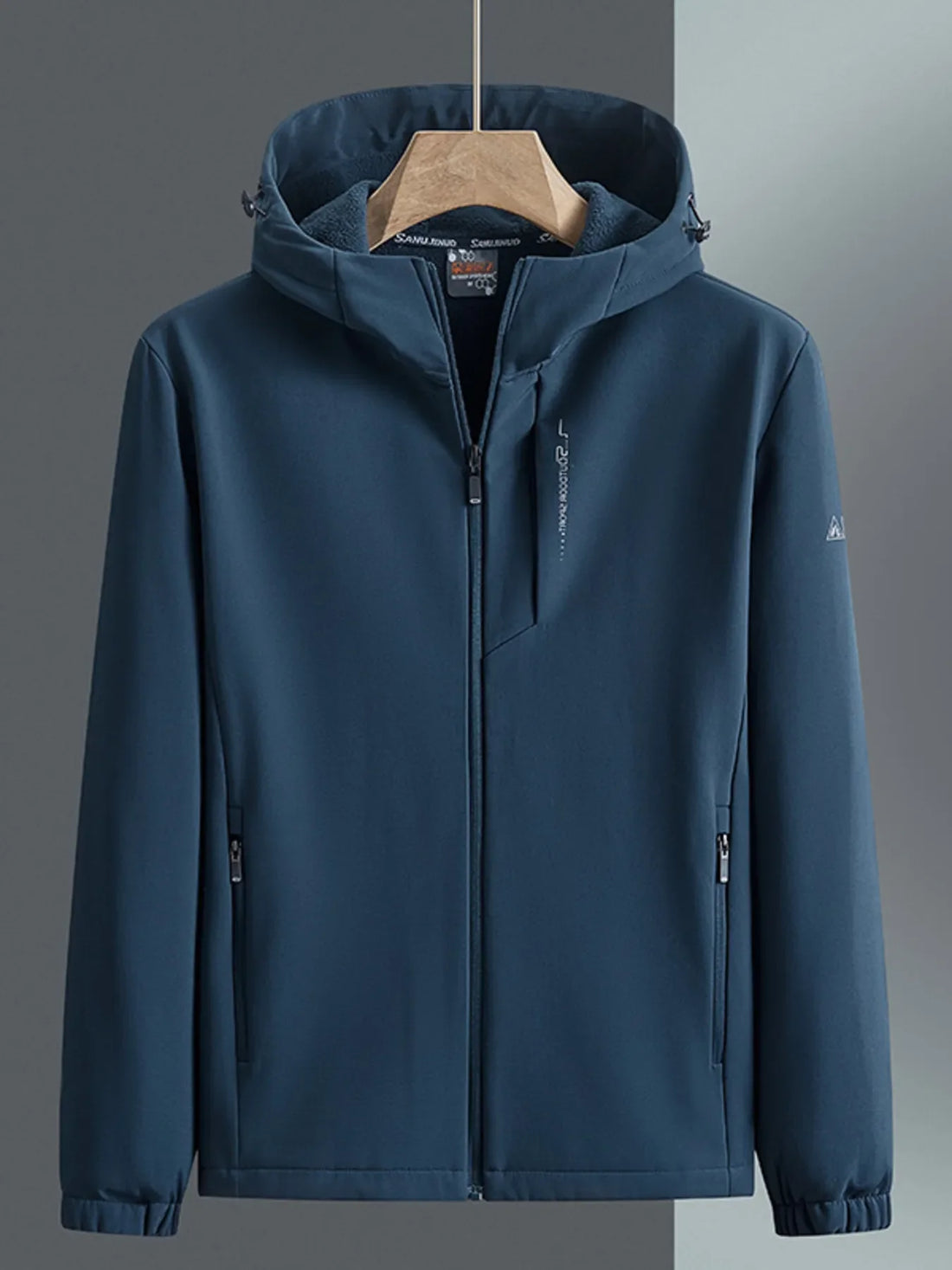 Men's hooded windbreaker in Peacock Blue with zippered pockets and subtle sleeve logo.