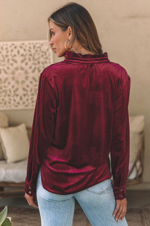 Burgundy velvet button-down blouse with mandarin collar and ruffled neckline detail.