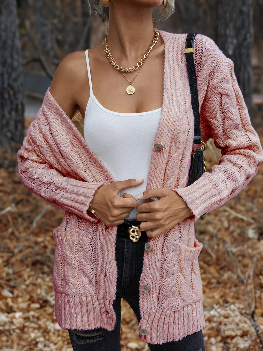 Carnation Pink cable knit cardigan with button front and pockets.