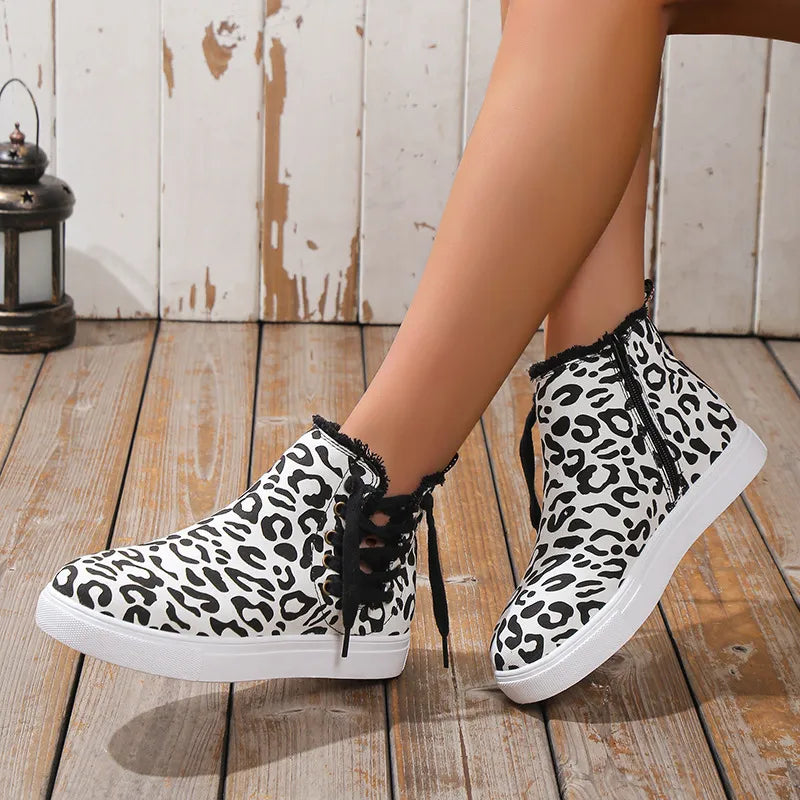 Canvas leopard print zip-up sneaker booties with lace-up detail and frayed trim.