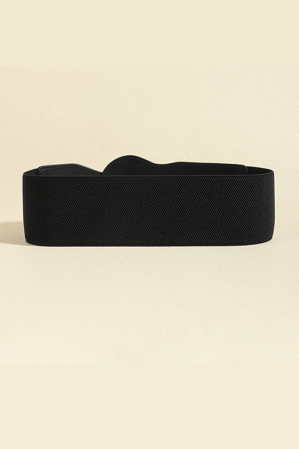 Black elastic waist belt with a sculpted shape and gold buckle detail.
