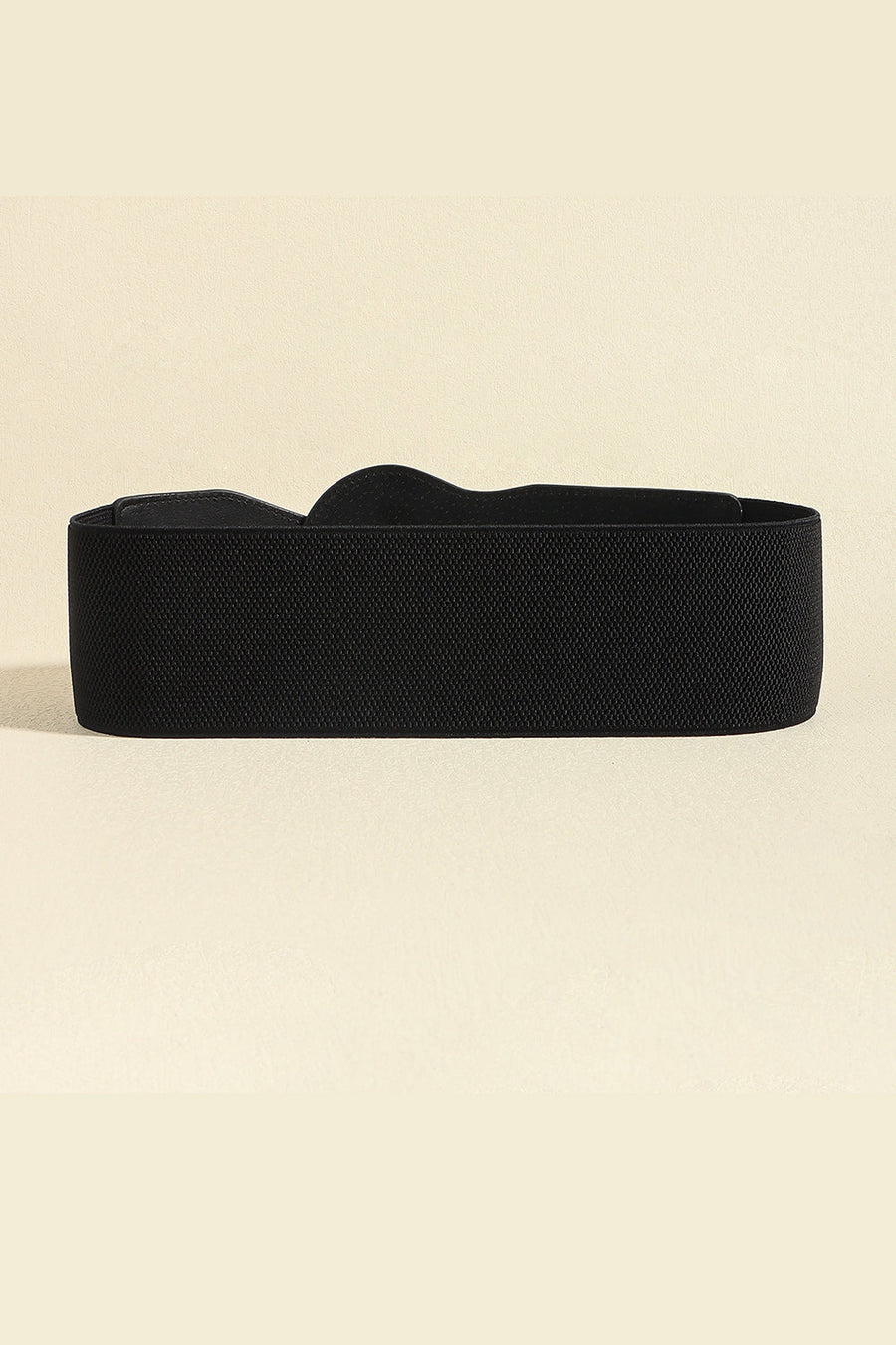 Black elastic waist belt with a sculpted shape and gold buckle detail.