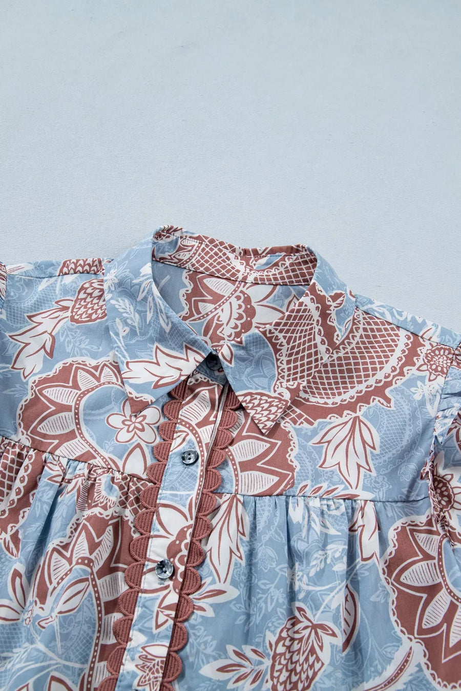 Blue cotton button-up shirt with floral pattern and scalloped trim detail