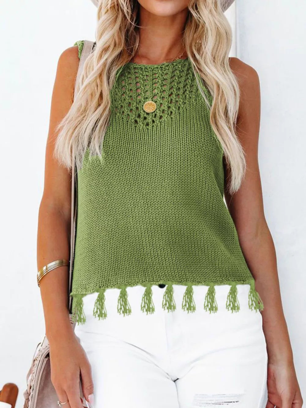 Green knit sleeveless tank top with crochet neckline and tassel hem
