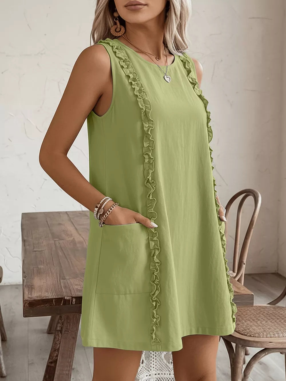 Yellow-Green sleeveless dress with frill detail and pockets.