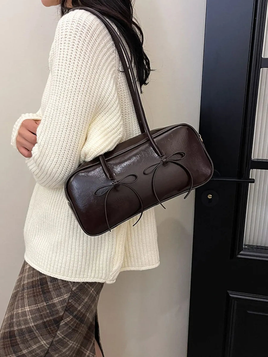 Brown patent leather shoulder bag with bow detail