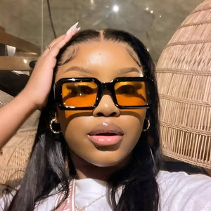 sunglasses in black featuring UV400 protection and rectangular fit