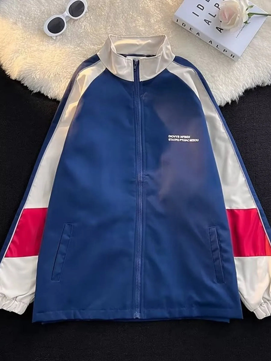 Men's blue zip-up track jacket with white and red colorblock sleeves and white collar.
