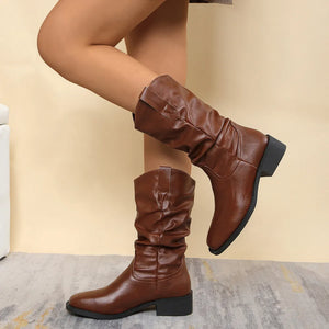 Brown slouchy western-inspired ankle boots with a pointed toe and block heel.