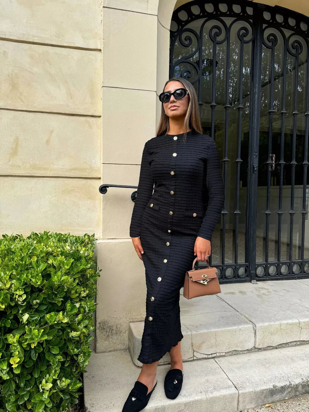 Black textured midi dress with crew neck and decorative gold buttons.