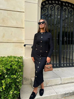 Black textured midi dress with crew neck and decorative gold buttons.