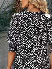 Black animal print half sleeve blouse with smocked cuffs and puff sleeves.