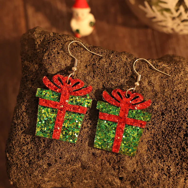 Festive glitter gift box drop earrings in green with red ribbon detail.