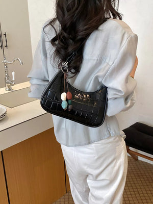shoulder bag in black with crocodile-embossed and textured