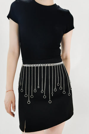 Silver chainmail belt with cascading chains and rings detail, worn at the waist.