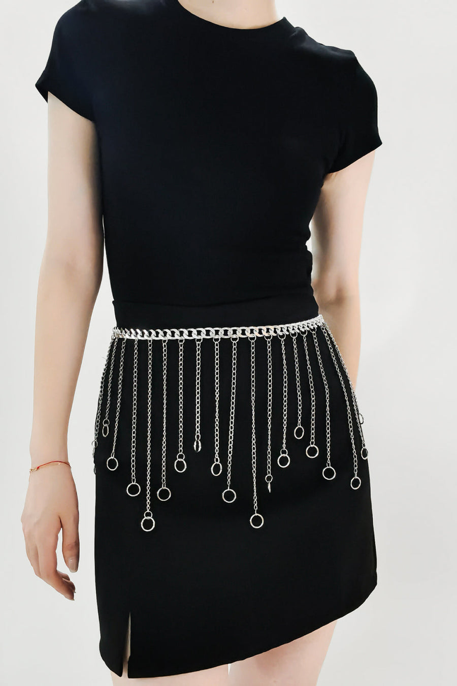 Silver chainmail belt with cascading chains and rings detail, worn at the waist.