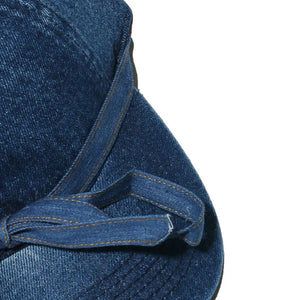 Denim baseball cap in navy with a tied bow detail on the strap.