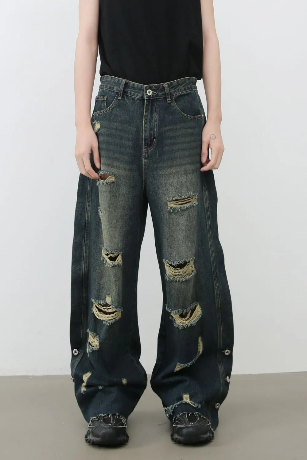 Distressed wide leg dark wash denim jeans with side slits and button detail