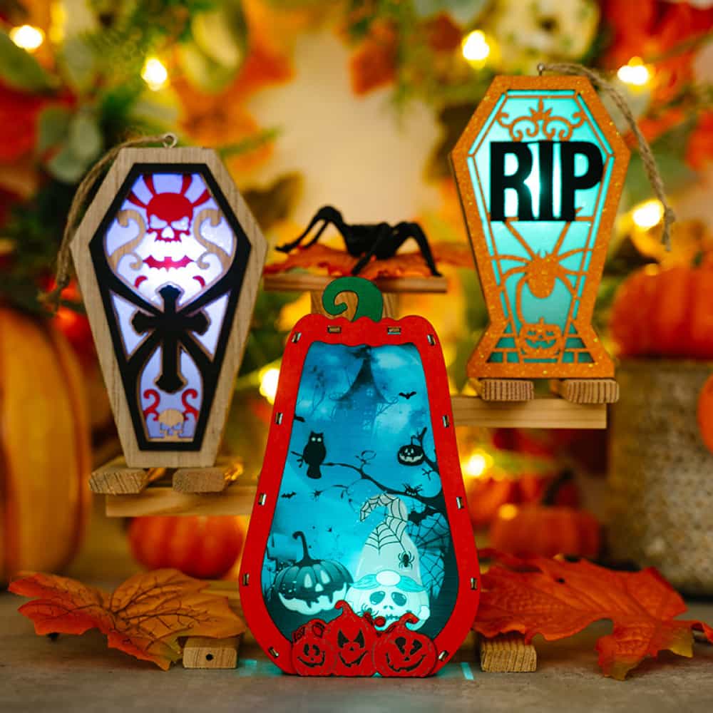 Spooky Silhouette Lantern Trio Ornaments: pumpkin, coffin with skull, RIP coffin with spider.