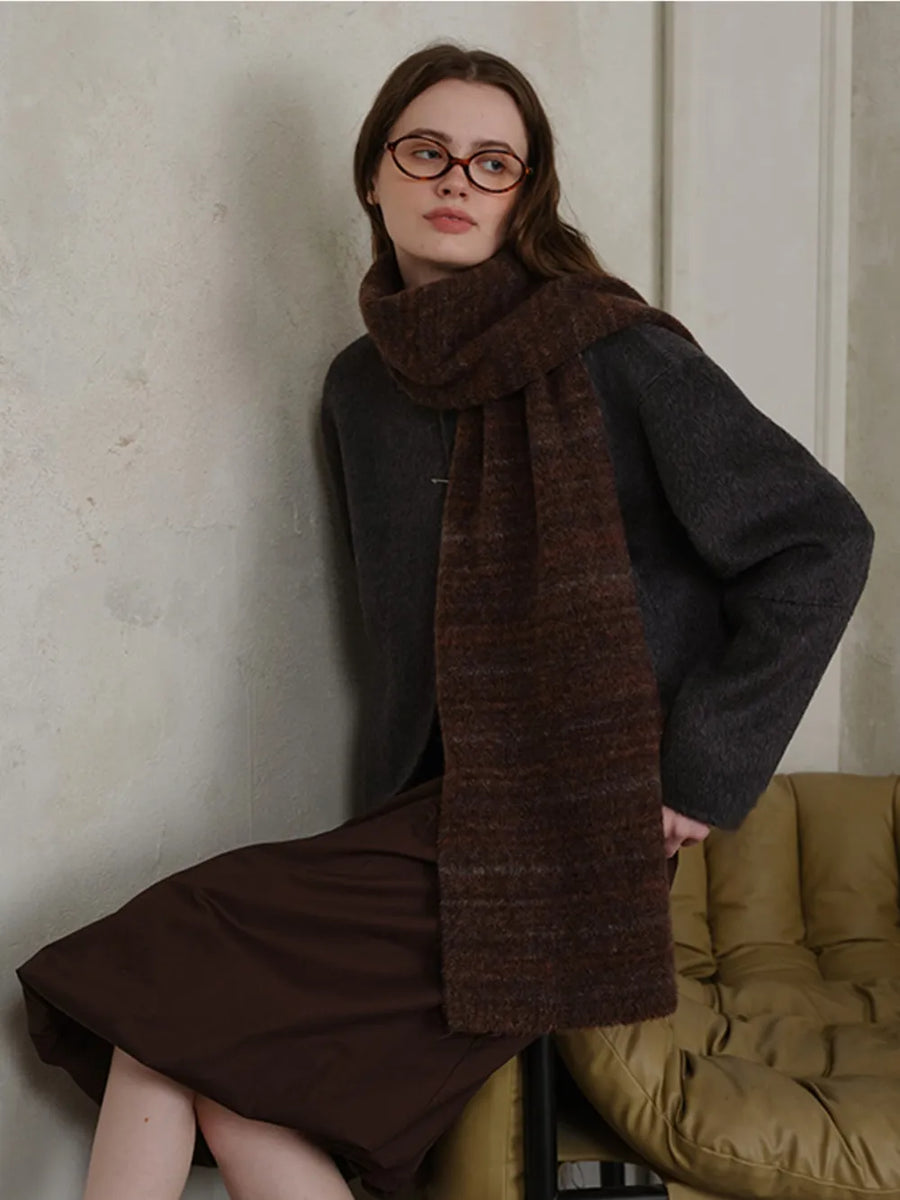 Textured mélange knit scarf in Chocolate, styled with a dark sweater and brown skirt.