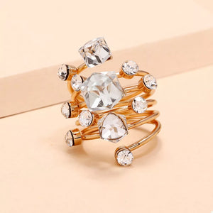 Glamorous gold-plated ring with clear crystals in various shapes and sizes, multi-layered spiral design.