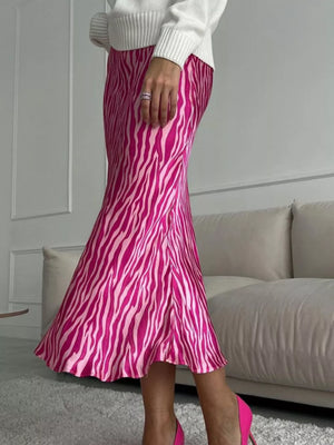 Satin slip skirt with pink zebra print, midi length, and a slight flare.