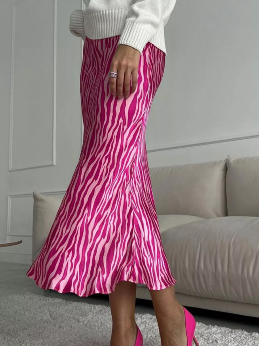 Satin slip skirt with pink zebra print, midi length, and a slight flare.