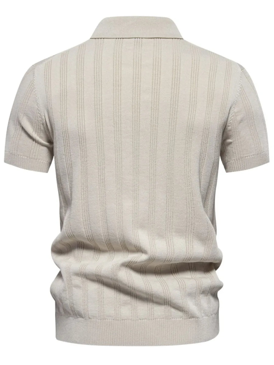 Beige ribbed knit polo shirt with vertical texture detail and short sleeves.