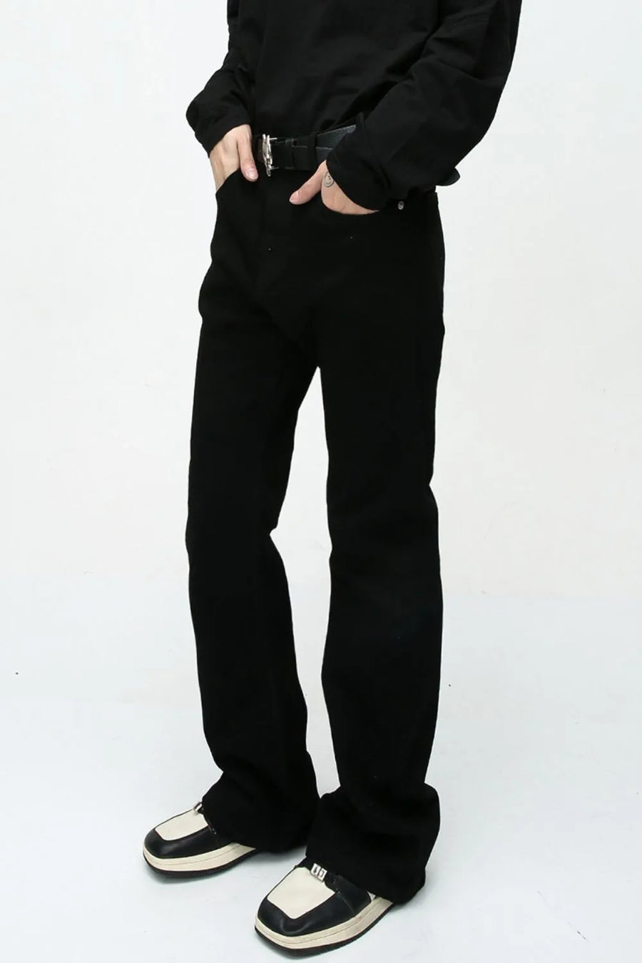 Flared leg black denim jeans with a casual 70s style.