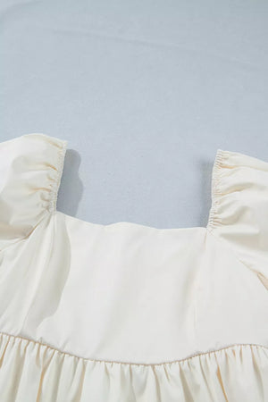 Cream puff sleeve dress with square neckline and ruffled hem detail.