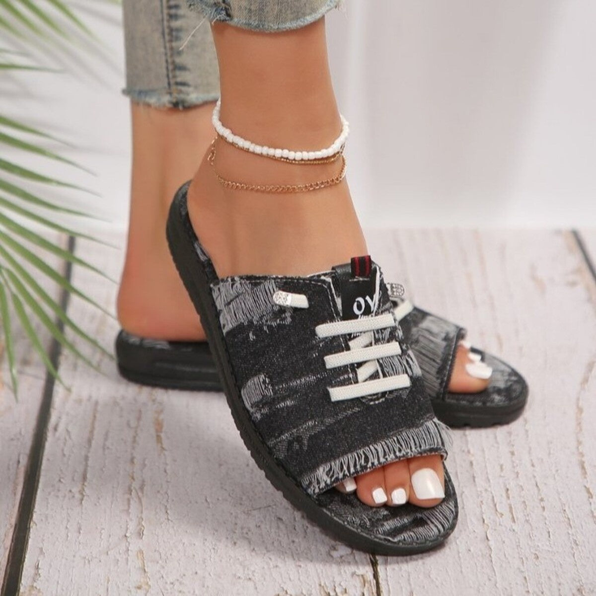 Black distressed canvas open-toe platform sandals with white laces and frayed edges.