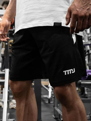 Black performance shorts with white logo detail and breathable fabric.